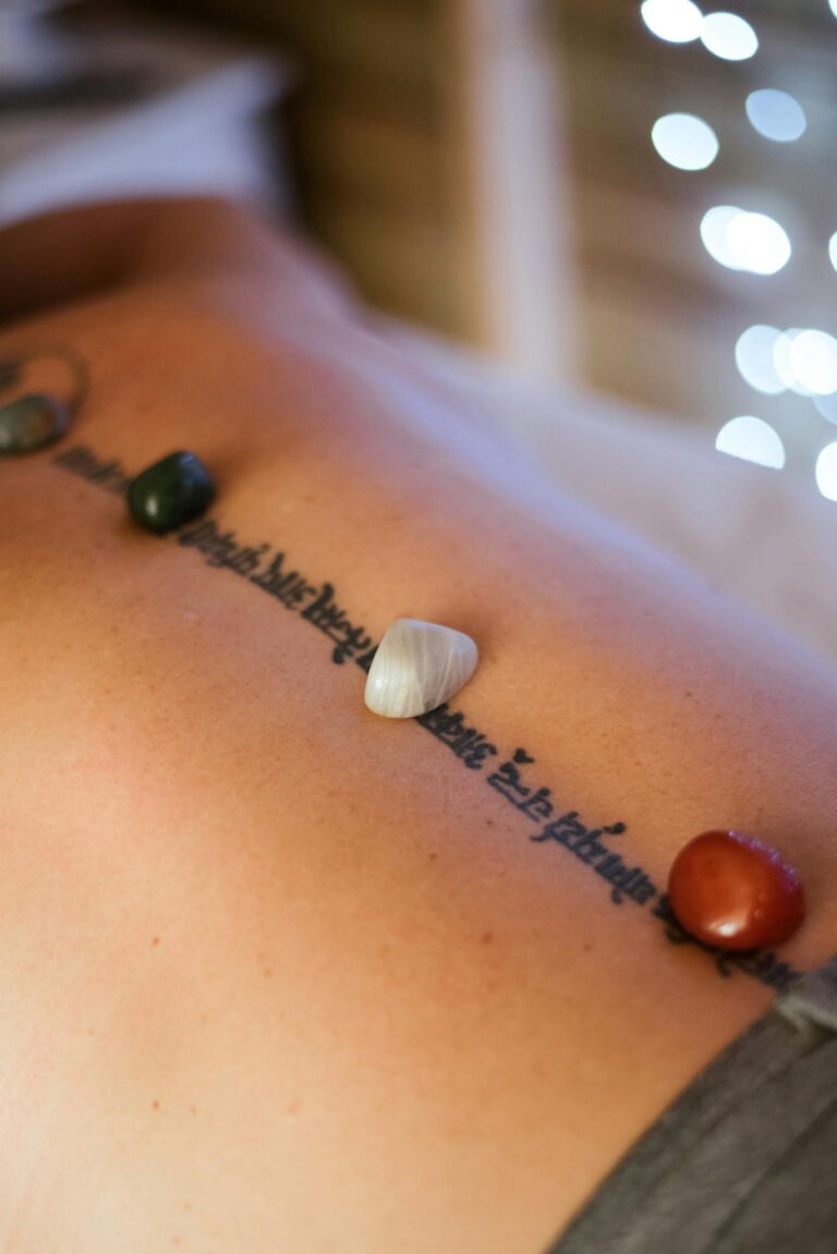 Crop woman with stones on back